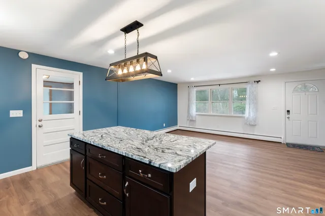 a kitchen with a wooden floor and a window