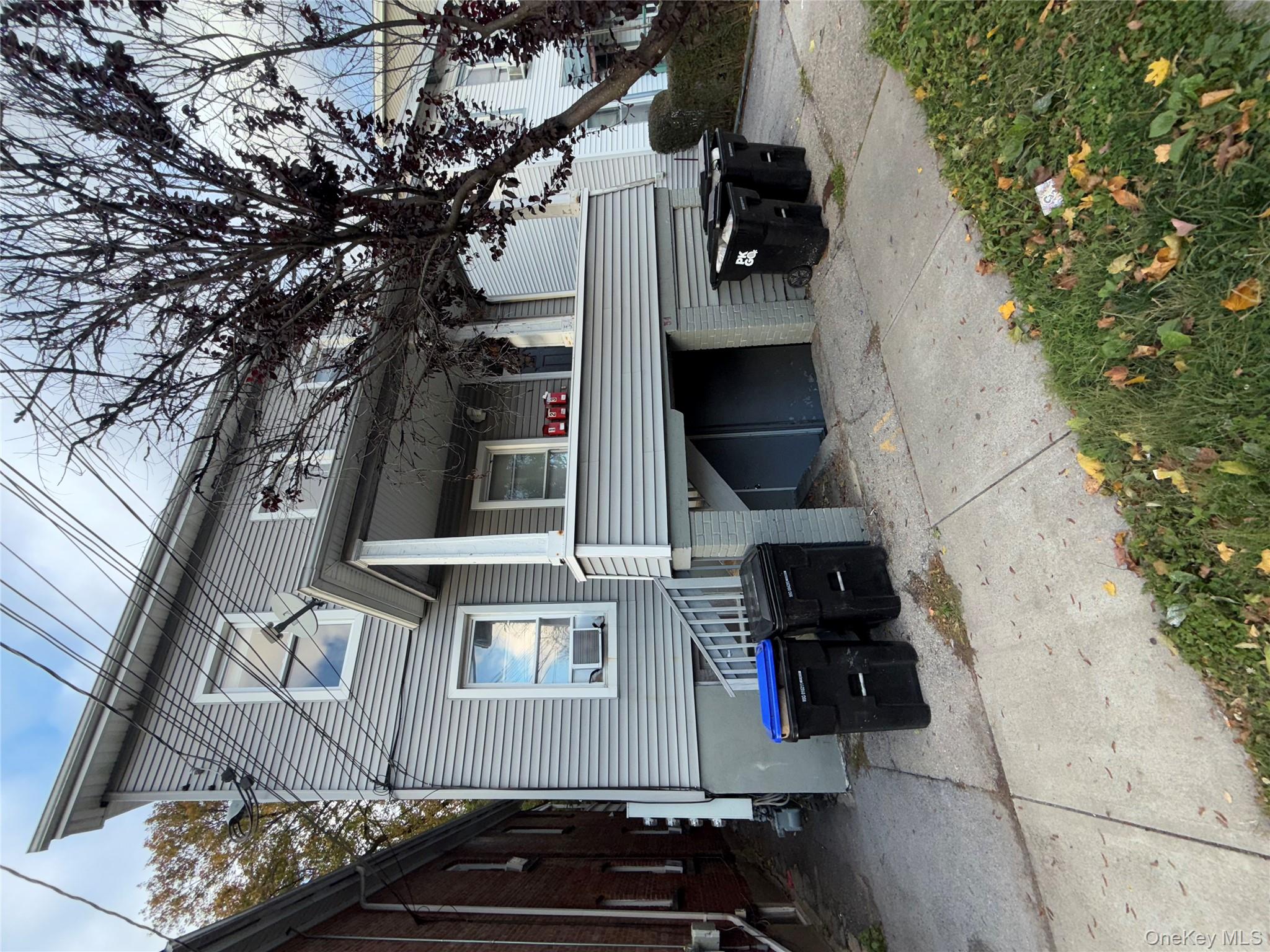 a view of a house with a yard and furniture