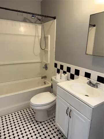a bathroom with a sink a toilet and a shower