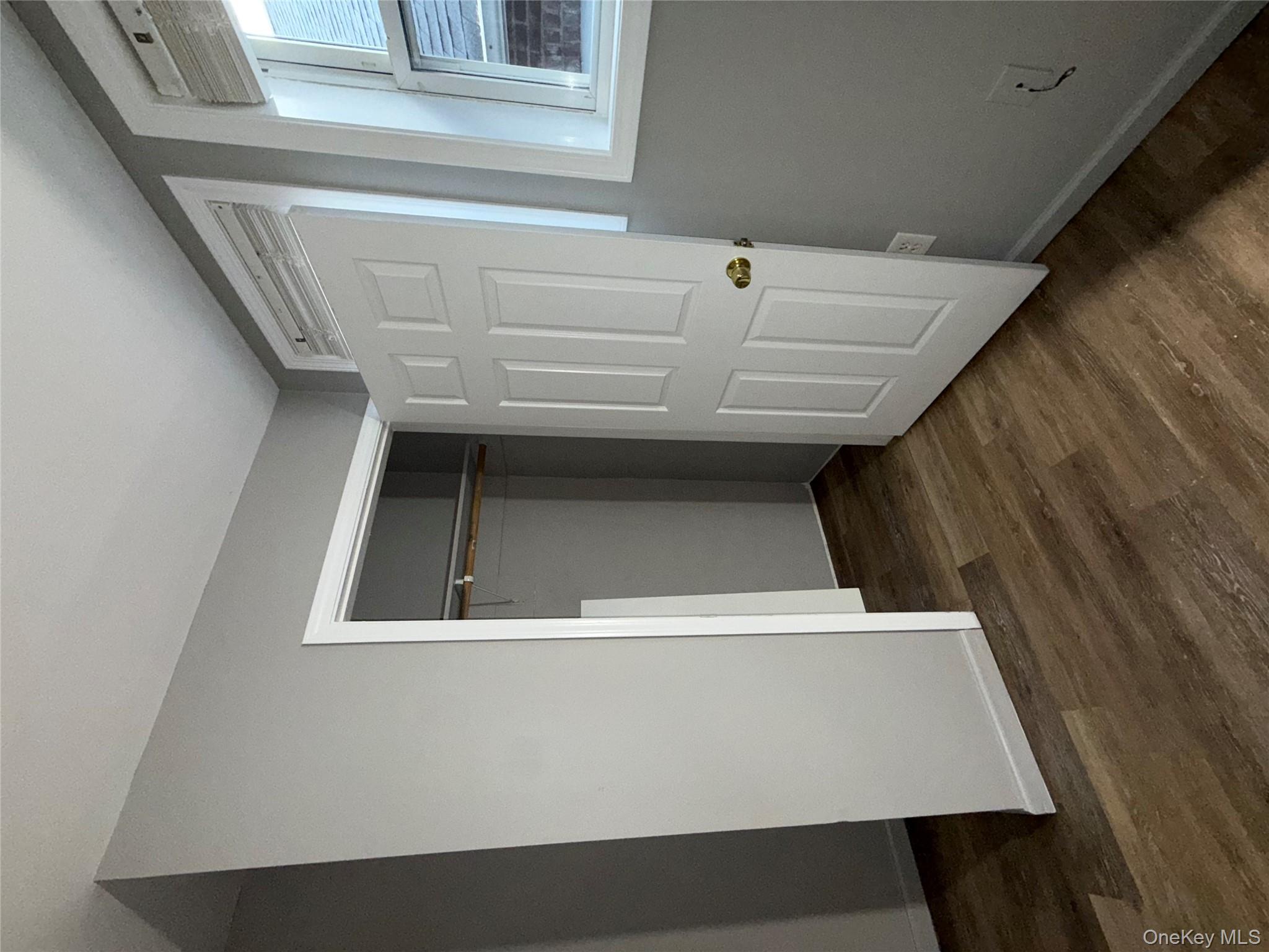 54 Gifford Avenue, Unit 2 Poughkeepsie, NY 12601 - Photo 16 of 19 a view of an empty room with wooden floor and a window
