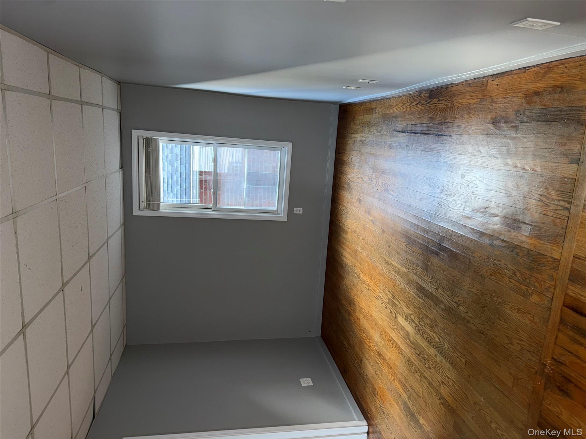 54 Gifford Avenue, Unit 2 Poughkeepsie, NY 12601 - Photo 5 of 19 an empty room with wooden floor and windows