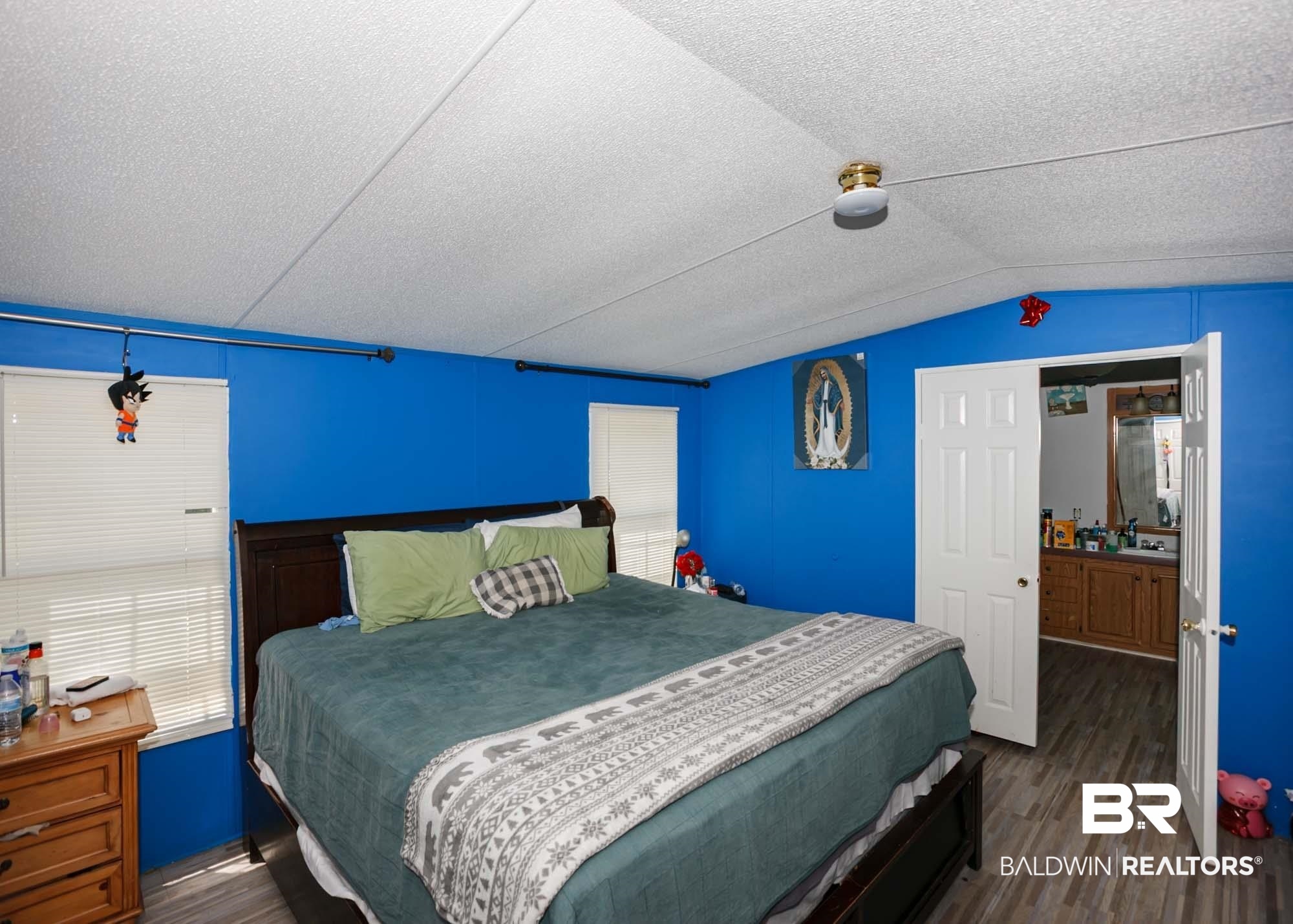 14005 County Road 49 Foley, AL 36535 - Photo 15 of 38 Bedroom featuring dark wood-style floors, a textured ceiling, and lofted ceiling