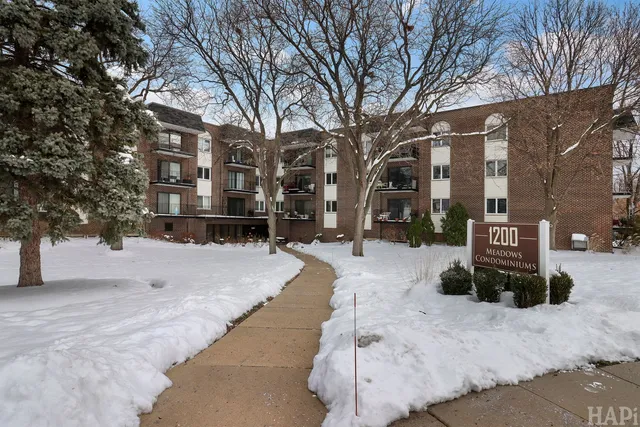 a view of a building with a yard covered in snow