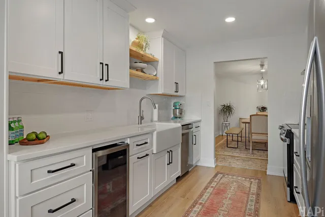 a kitchen with stainless steel appliances a refrigerator sink and stove