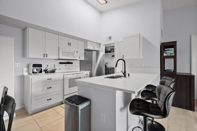 a kitchen that has a sink and a stove