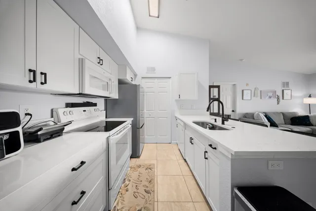 a view of kitchen with furniture and refrigerator