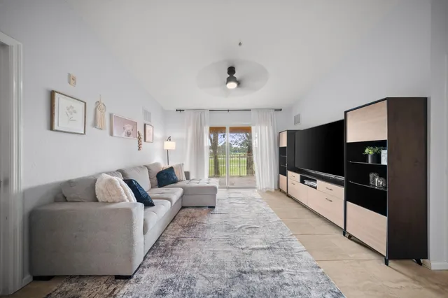 a spacious bedroom with a bed and a flat screen tv