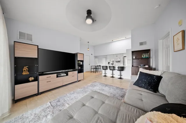 a bedroom with a bed chandelier and a window