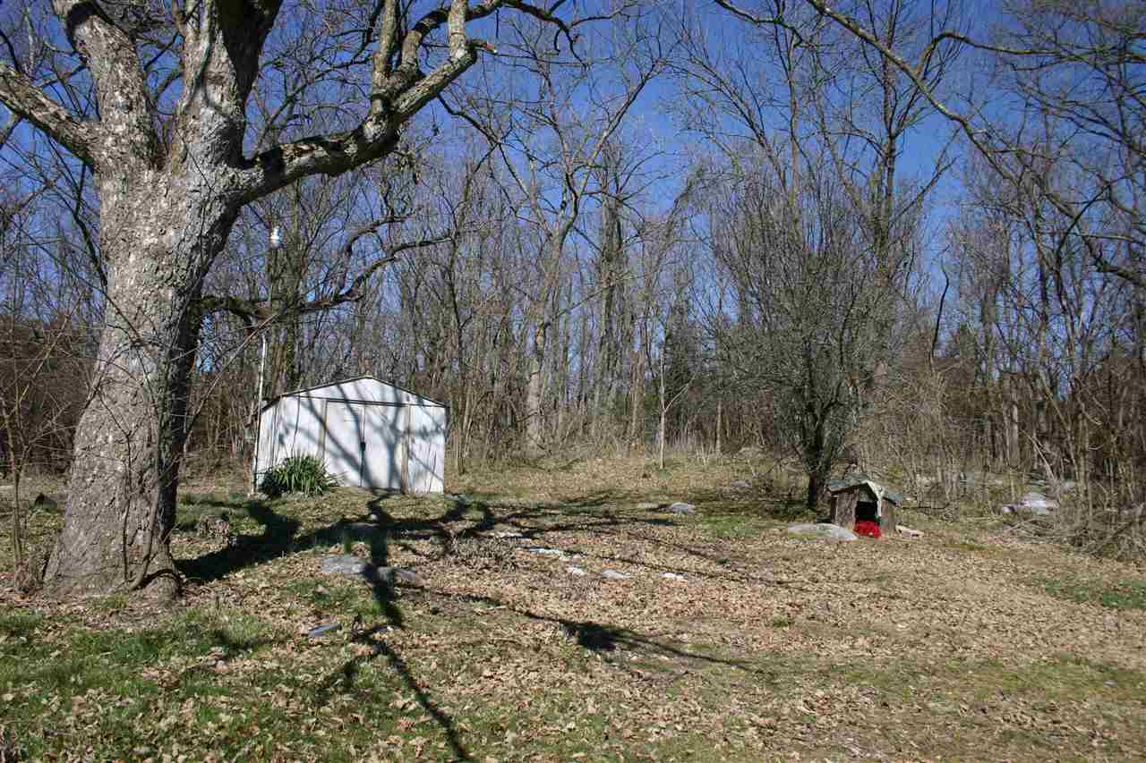 1661 Smithland Road Harrisonburg, VA 22802 - Photo 6 of 6 a backyard of a house with large trees and a wooden fence