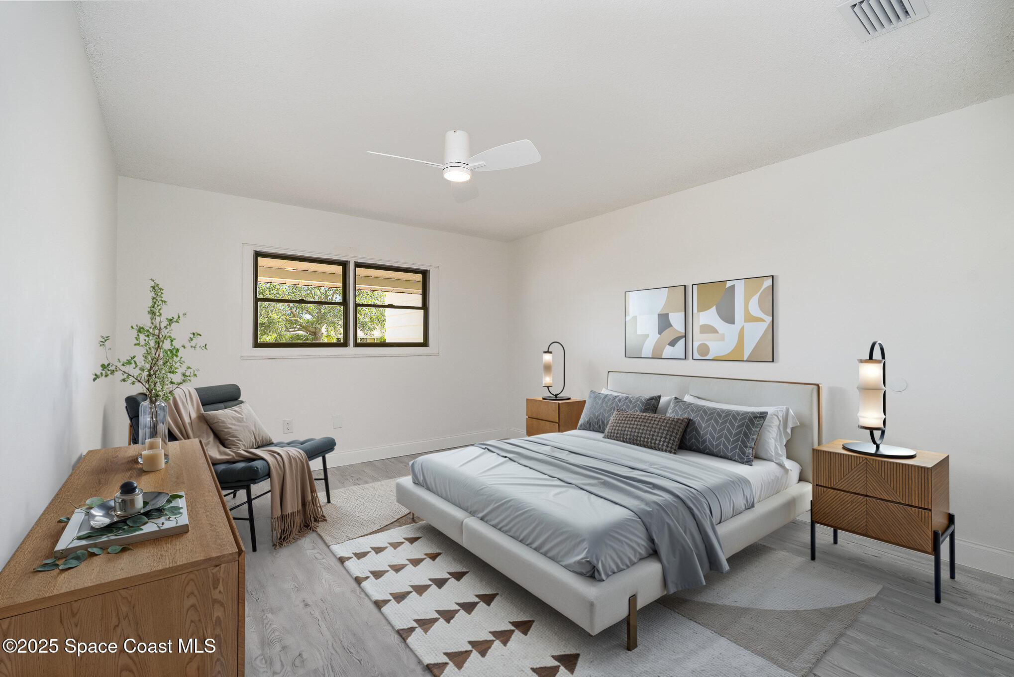 906 Kings Post Road Rockledge, FL 32955 - Photo 14 of 31 a bedroom with a bed a couch and a potted plant