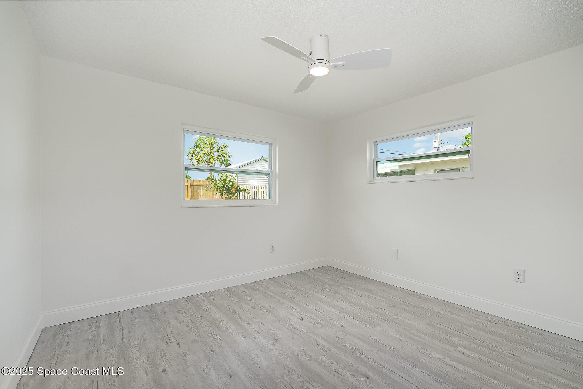 906 Kings Post Road Rockledge, FL 32955 - Photo 15 of 31 wooden floor in an empty room with a window