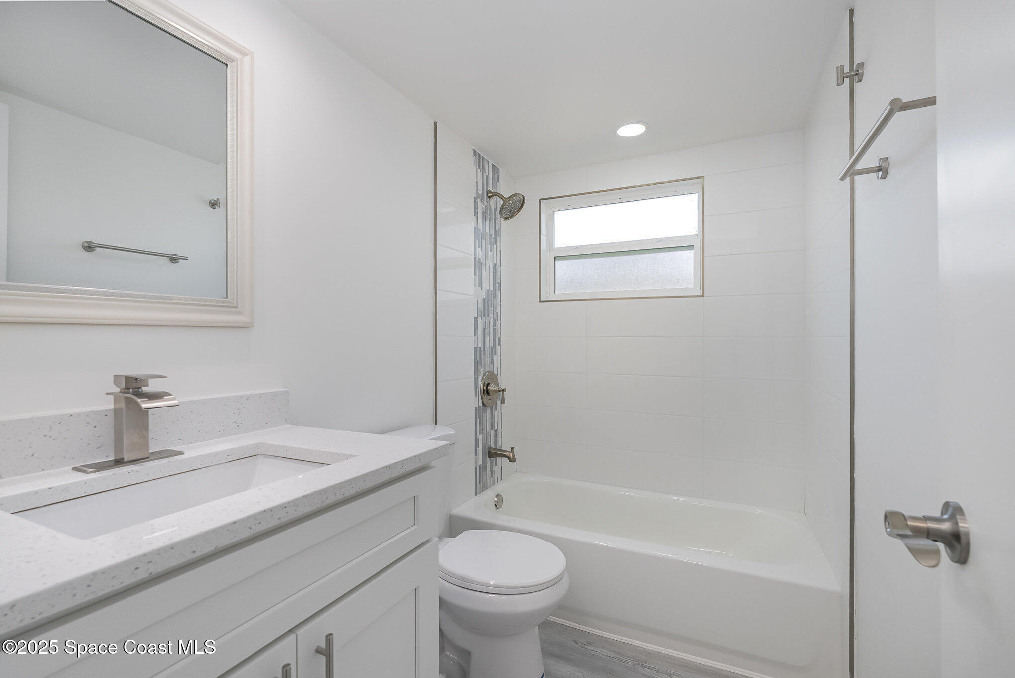 906 Kings Post Road Rockledge, FL 32955 - Photo 16 of 31 a bathroom with a sink a toilet and shower