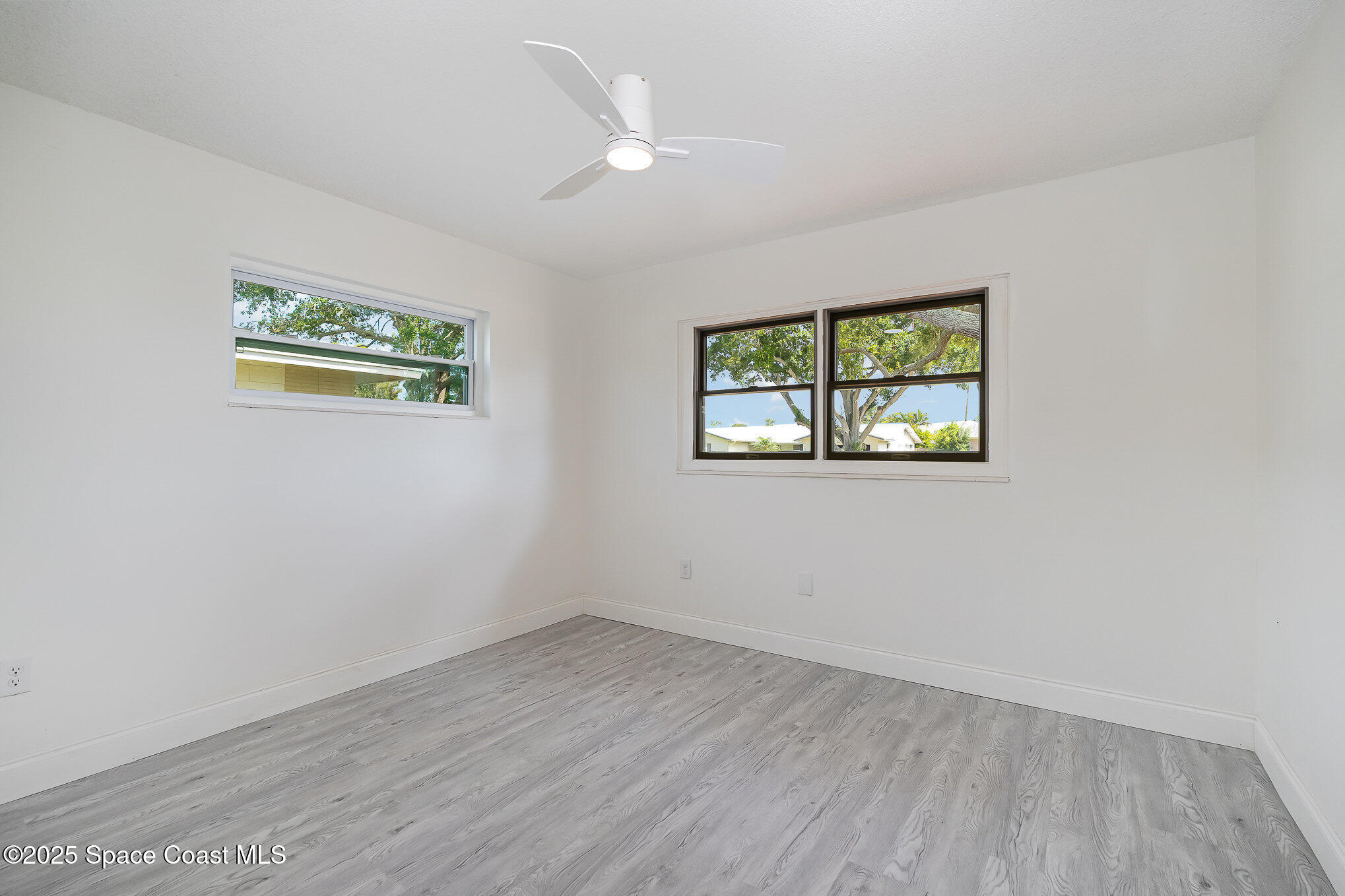 906 Kings Post Road Rockledge, FL 32955 - Photo 20 of 31 wooden floor in an empty room with a window