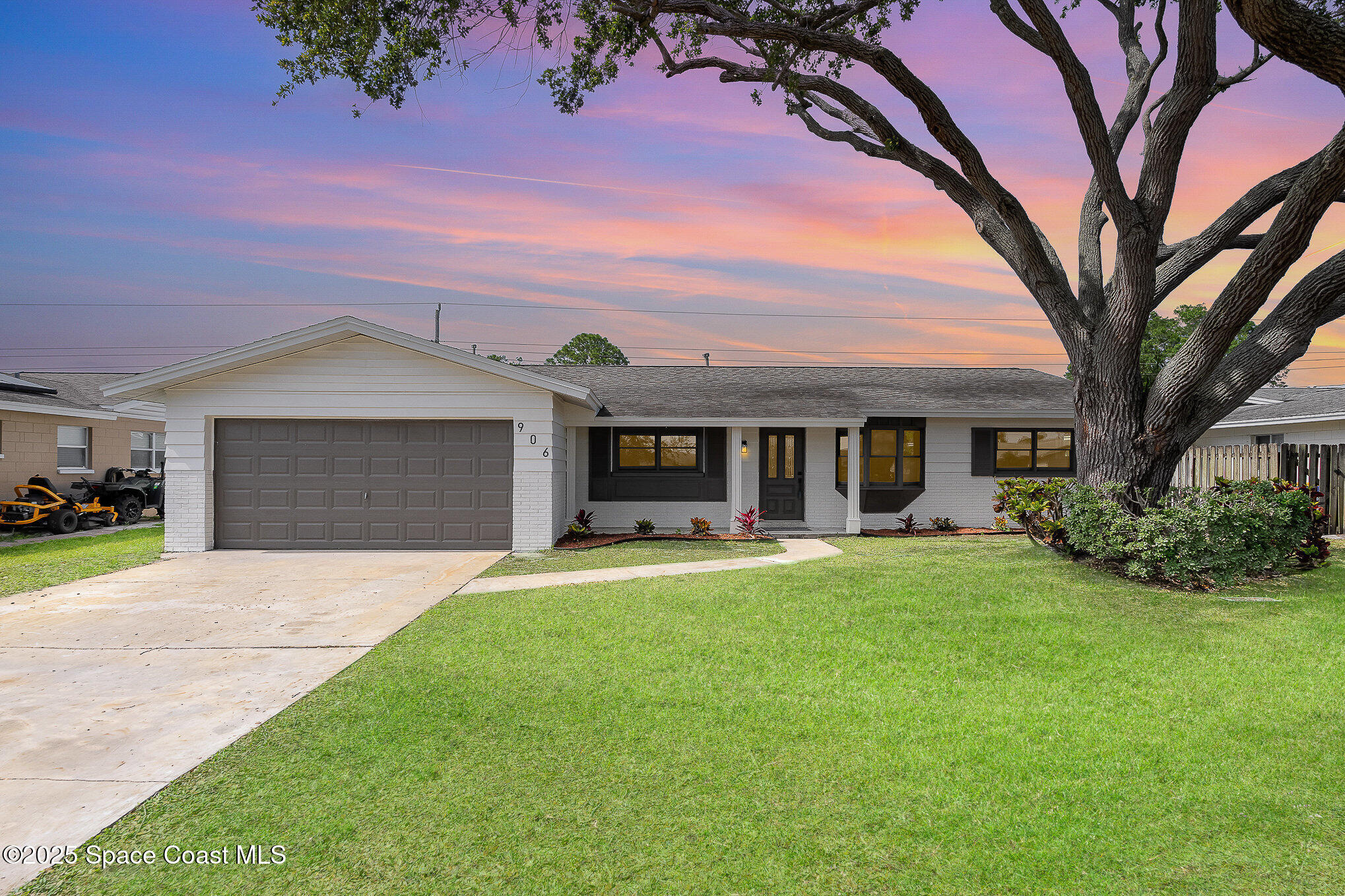 906 Kings Post Road Rockledge, FL 32955 - Photo 3 of 31 a front view of a house with a garden and trees