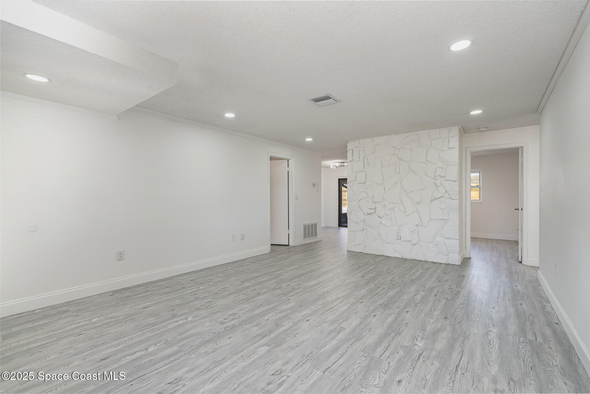 906 Kings Post Road Rockledge, FL 32955 - Photo 8 of 31 a view of an empty room with wooden floor