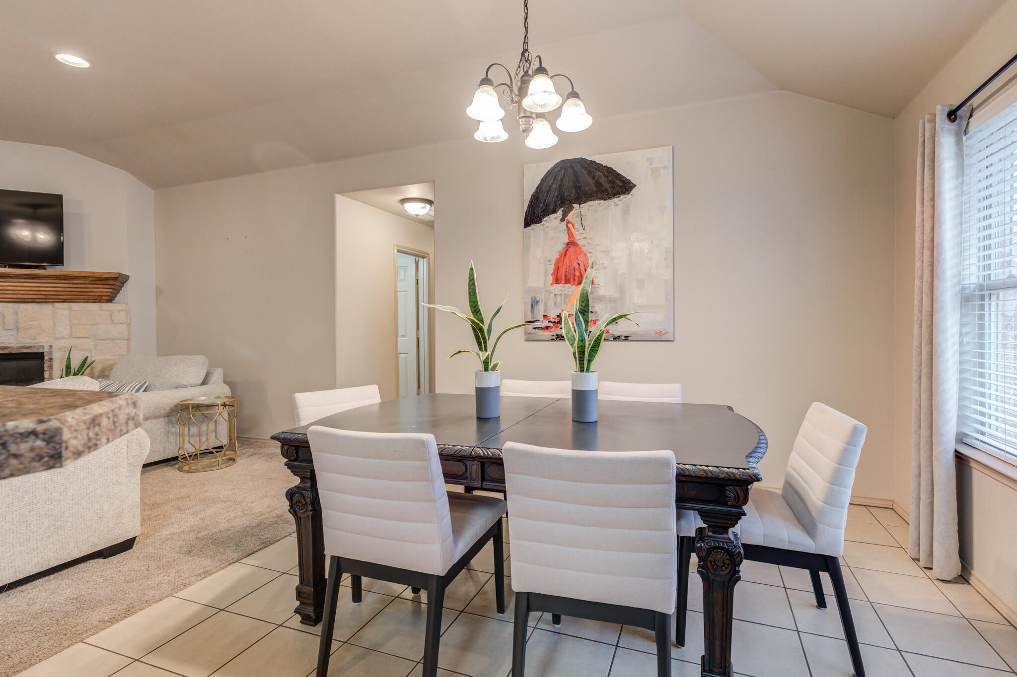 2206 101st Street Lubbock, TX 79423 - Photo 12 of 37 a view of a dining room with furniture and chandelier
