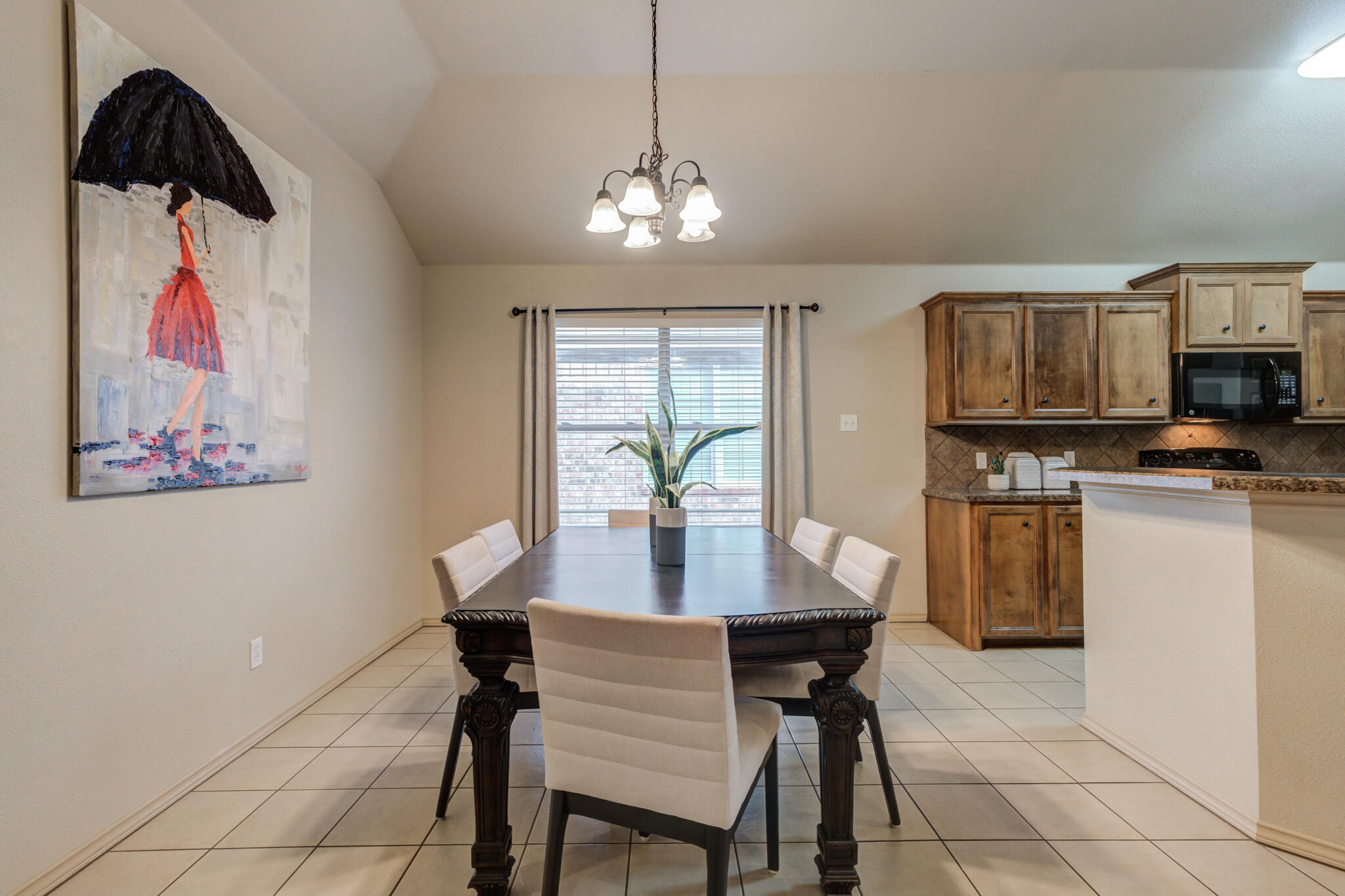 2206 101st Street Lubbock, TX 79423 - Photo 14 of 37 a view of a dining room with furniture and chandelier