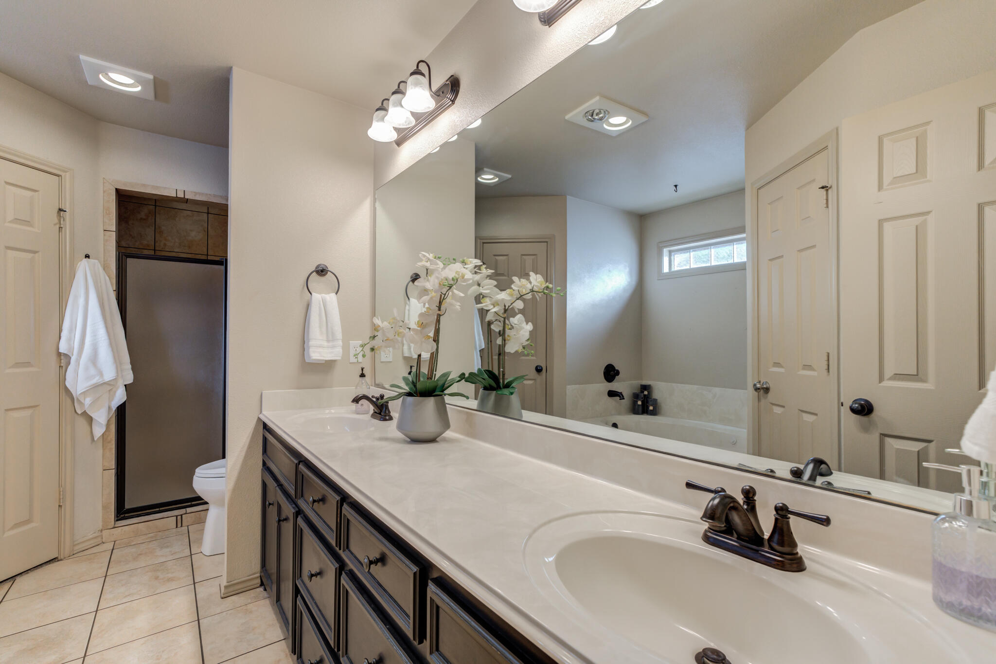 2206 101st Street Lubbock, TX 79423 - Photo 24 of 37 a bathroom with double vanity sink and a mirror