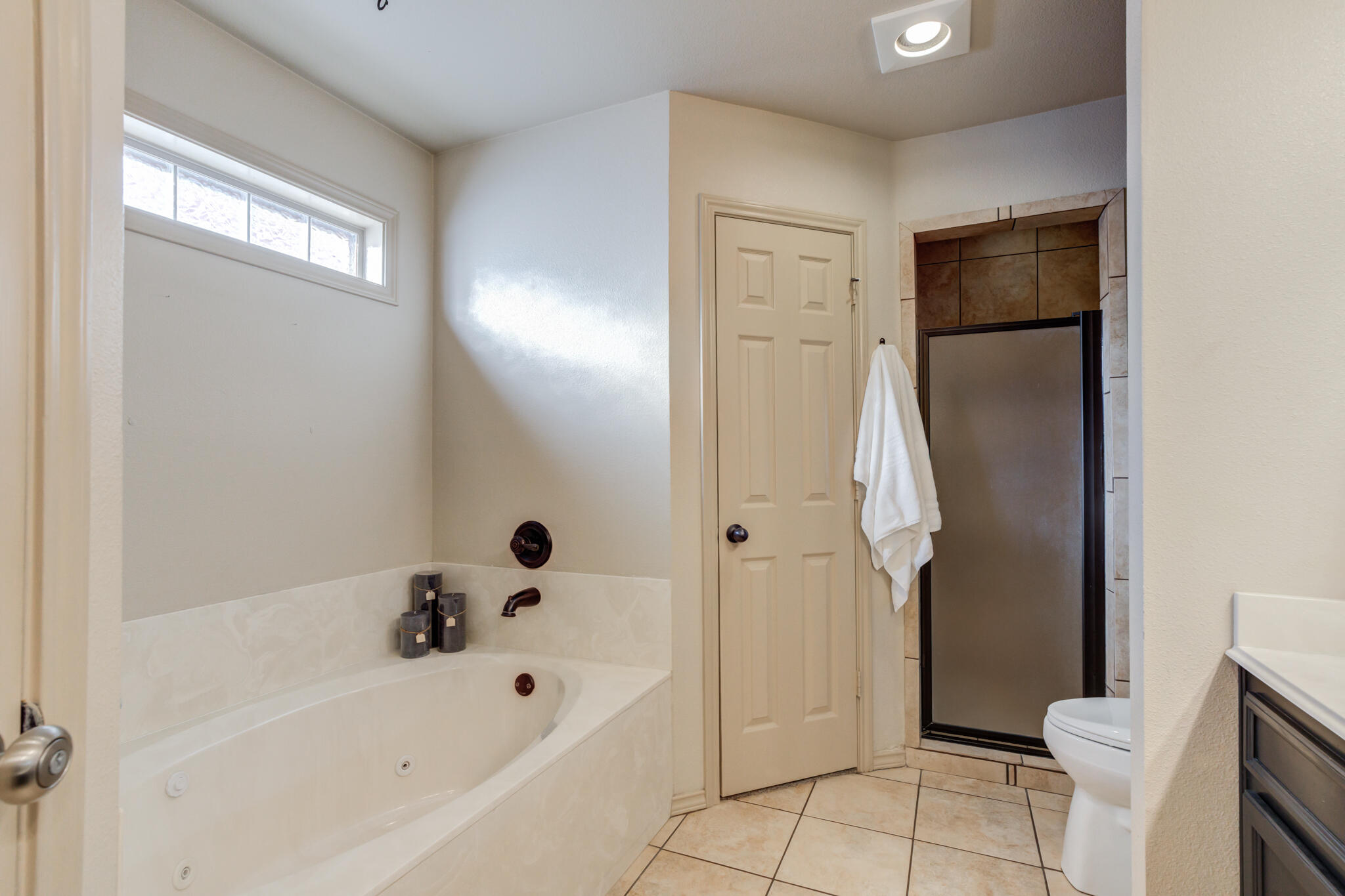 2206 101st Street Lubbock, TX 79423 - Photo 25 of 37 a bathroom with a bathtub and a shower