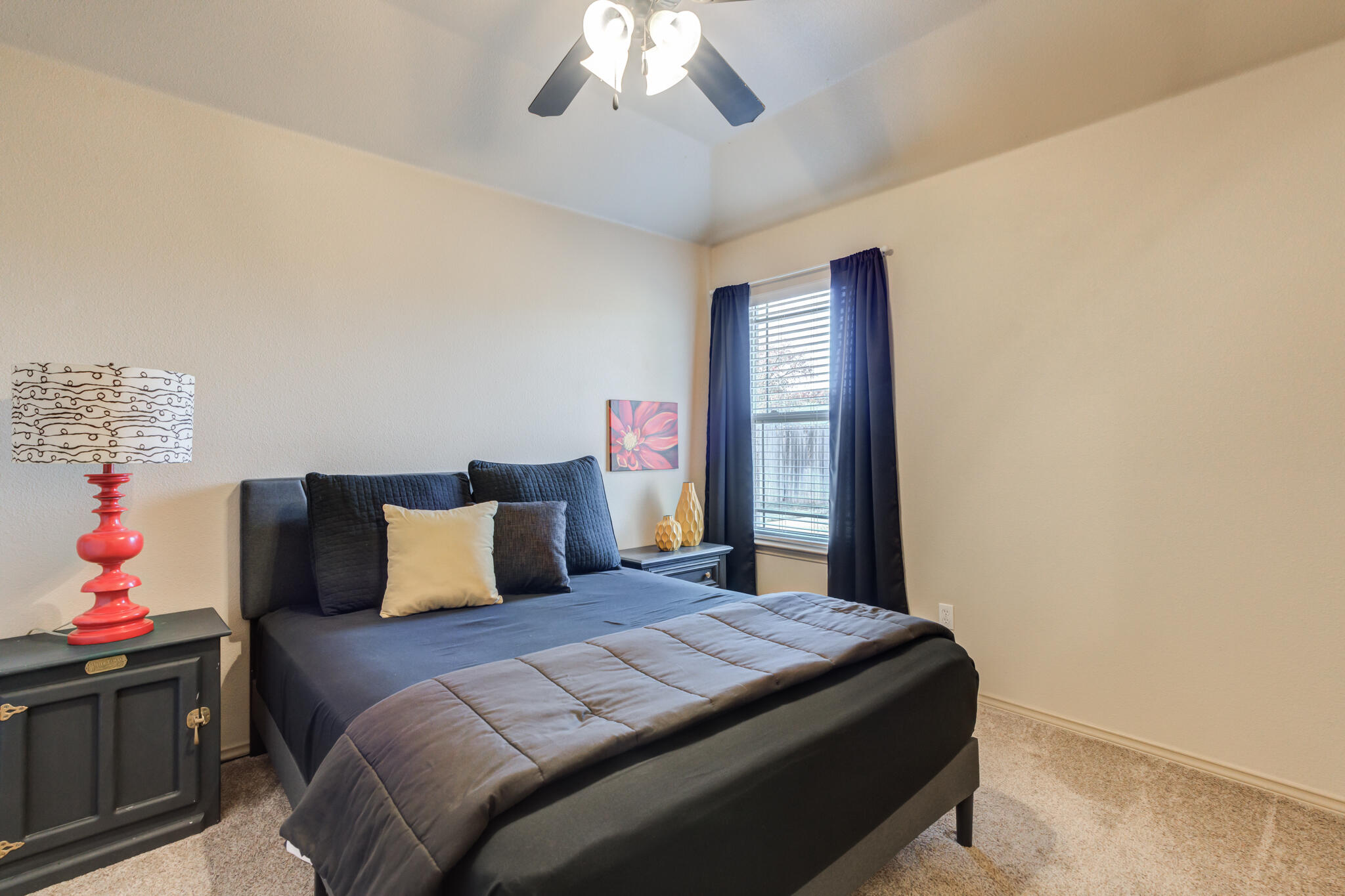 2206 101st Street Lubbock, TX 79423 - Photo 26 of 37 a bedroom with a bed and a chandelier