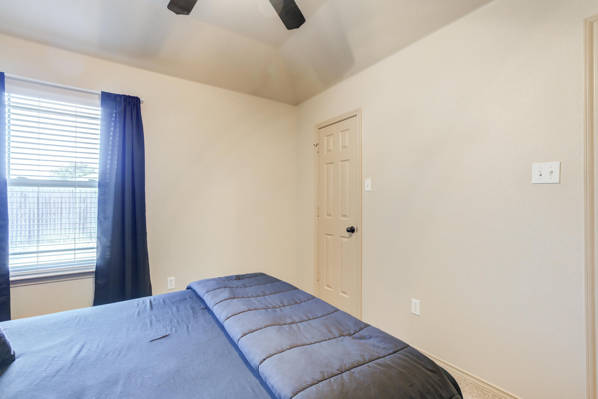 2206 101st Street Lubbock, TX 79423 - Photo 27 of 37 a bedroom with a bed and a window