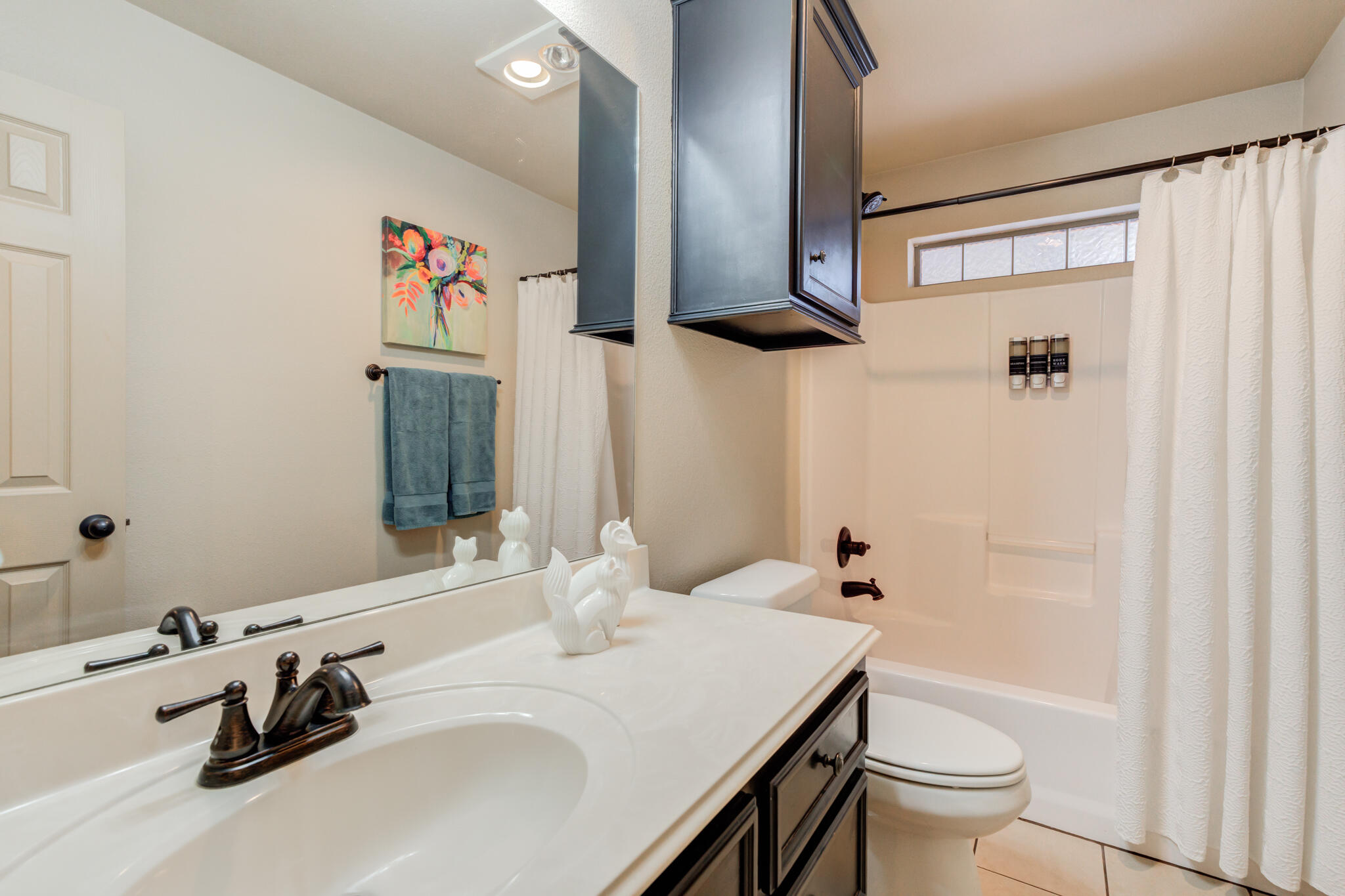 2206 101st Street Lubbock, TX 79423 - Photo 28 of 37 a bathroom with a sink and a mirror