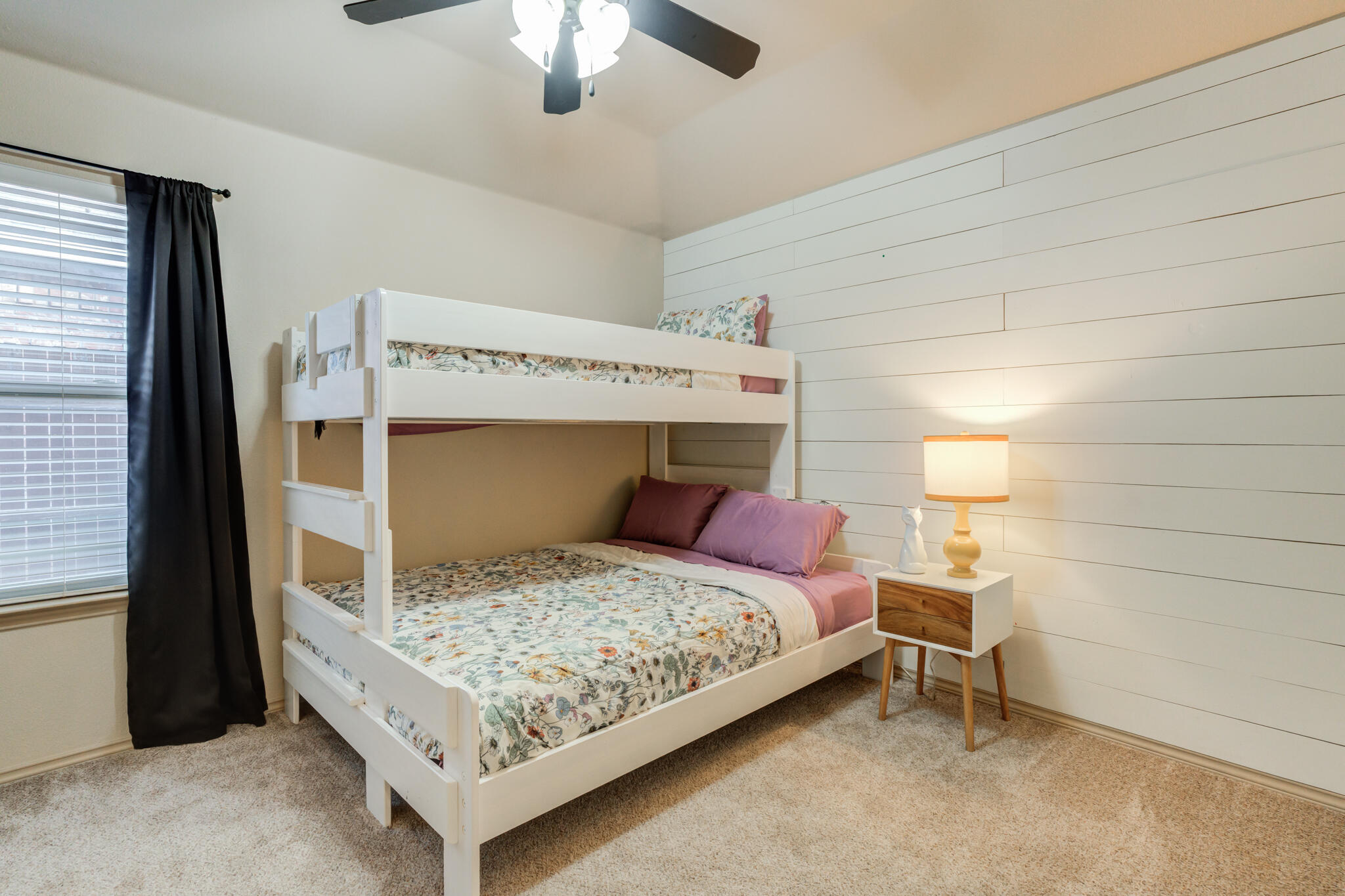 2206 101st Street Lubbock, TX 79423 - Photo 30 of 37 a bedroom with a bed and a chandelier