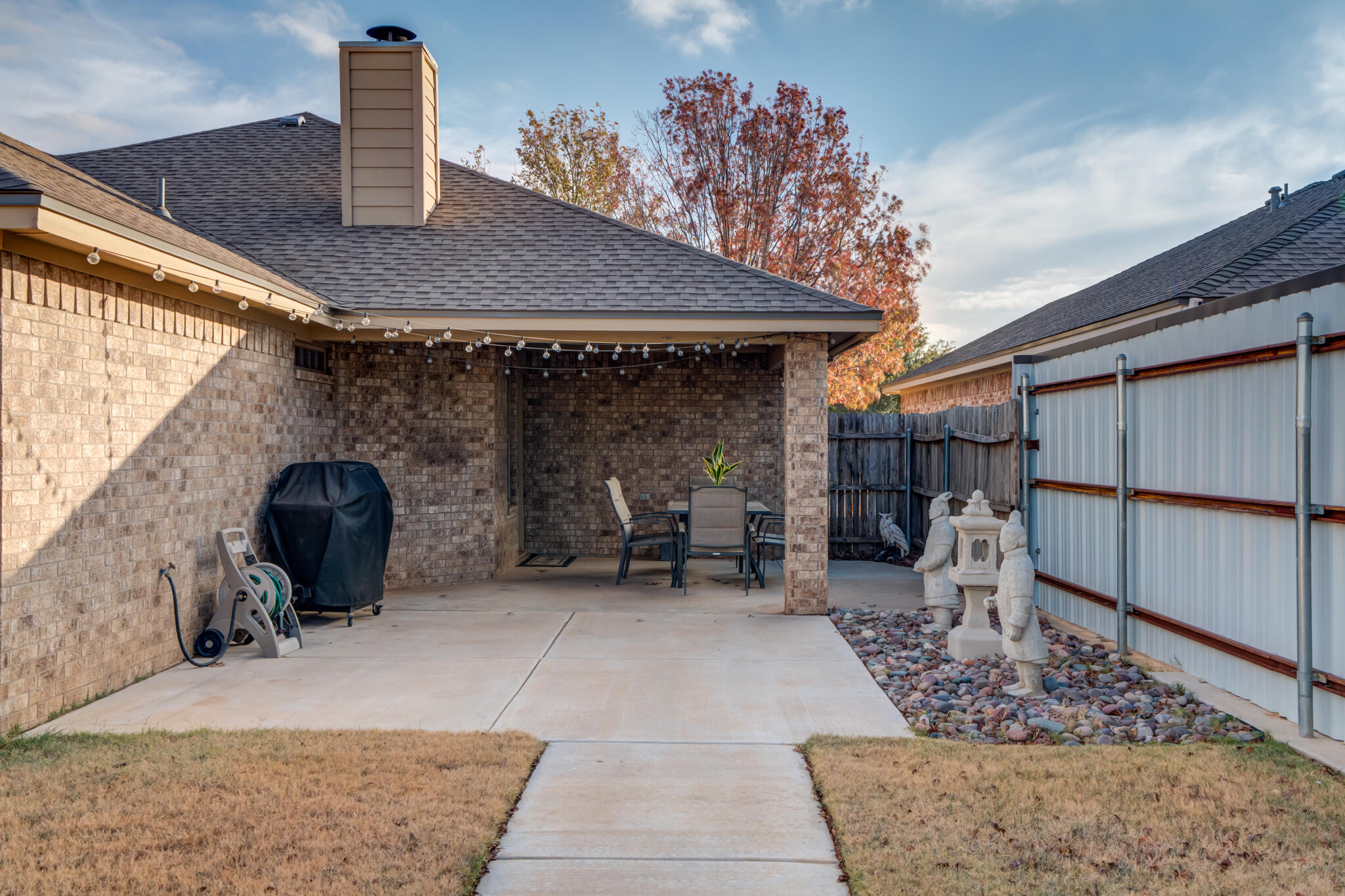 2206 101st Street Lubbock, TX 79423 - Photo 34 of 37 a view of a patio with a table and chairs