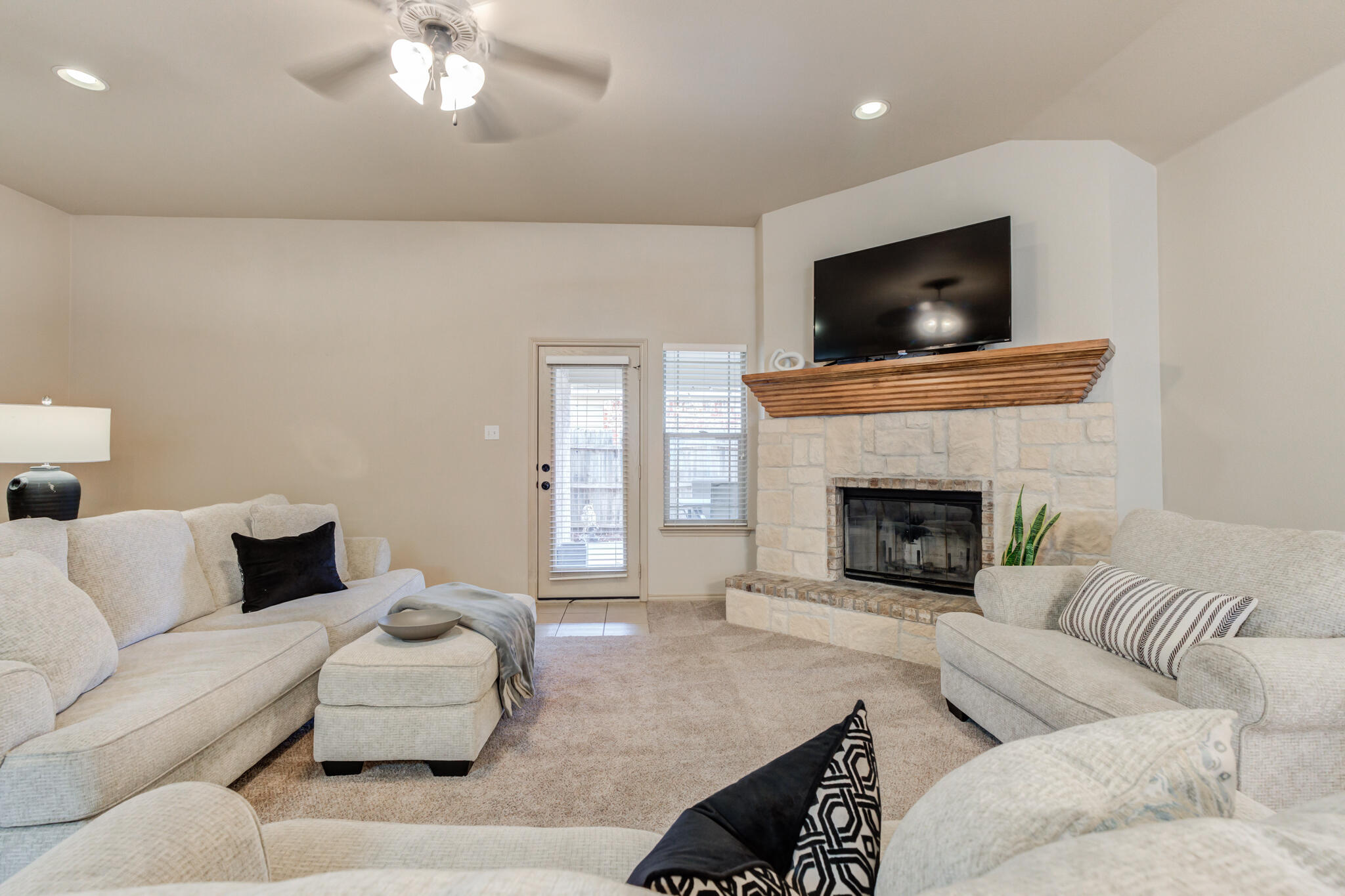 2206 101st Street Lubbock, TX 79423 - Photo 7 of 37 a living room with furniture and a flat screen tv