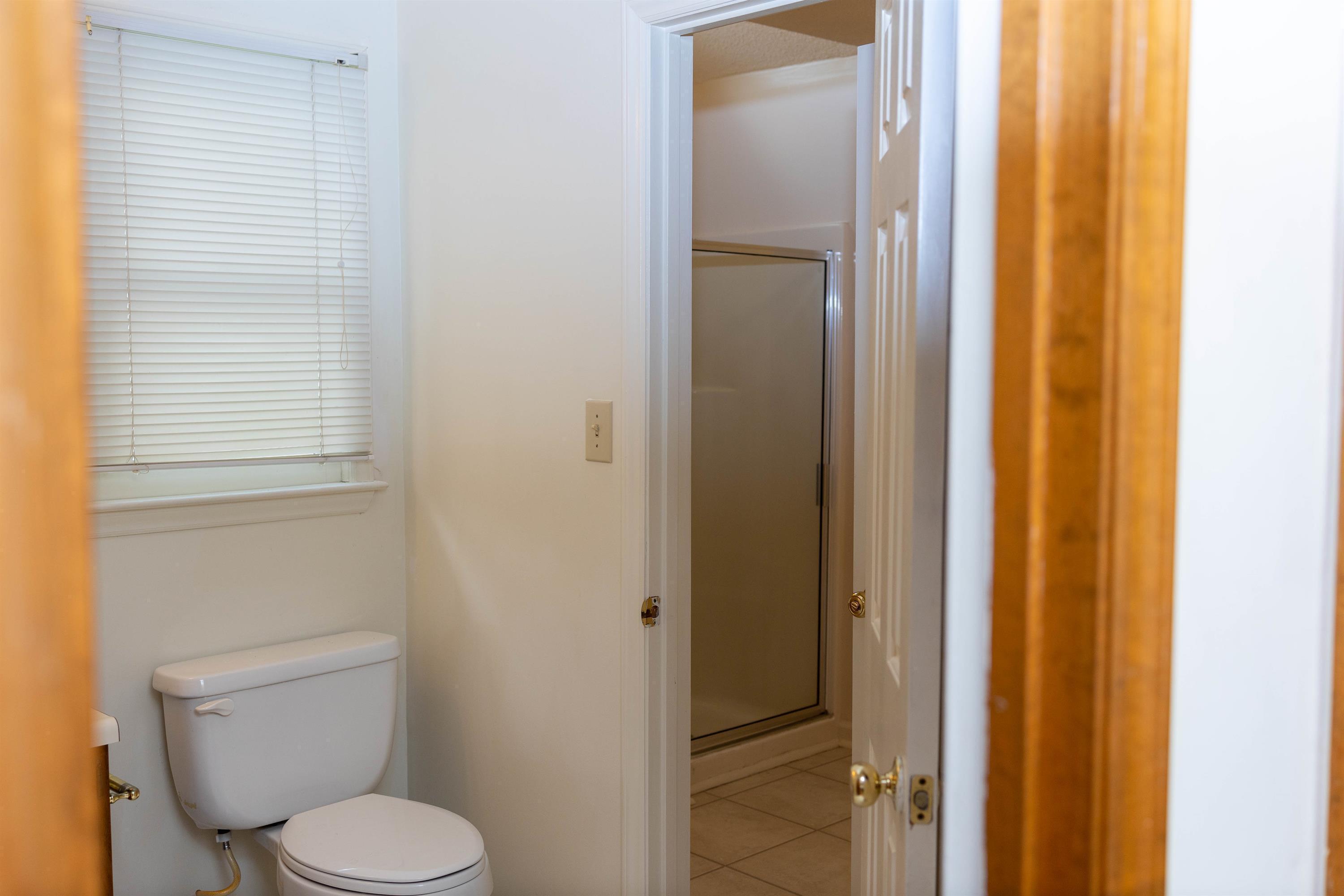 2704 Moorsfield Court Raleigh, NC 27604 - Photo 13 of 25 a white toilet sitting next to a bathroom sink