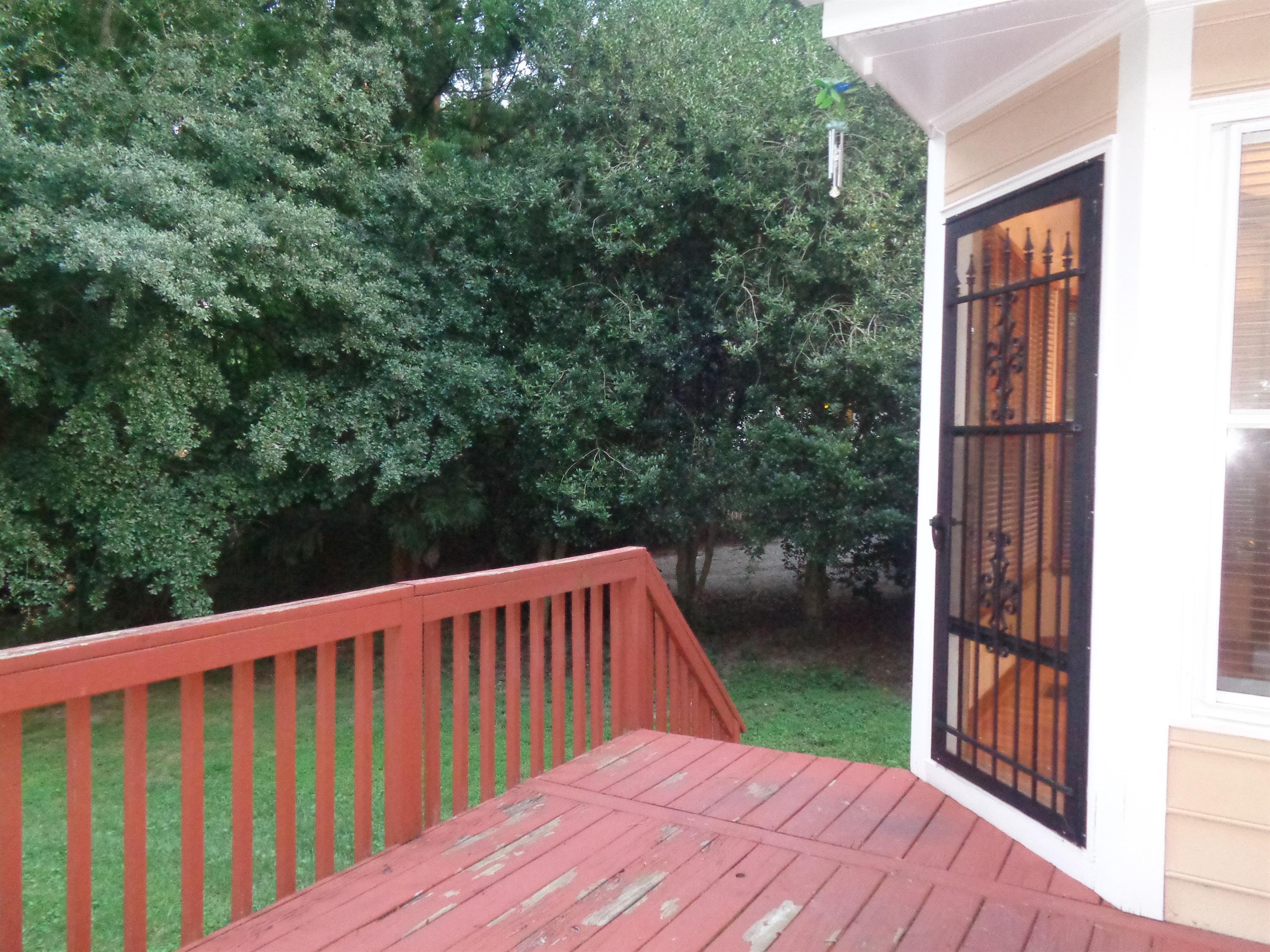 2704 Moorsfield Court Raleigh, NC 27604 - Photo 23 of 25 a balcony with wooden floor and yard in the back