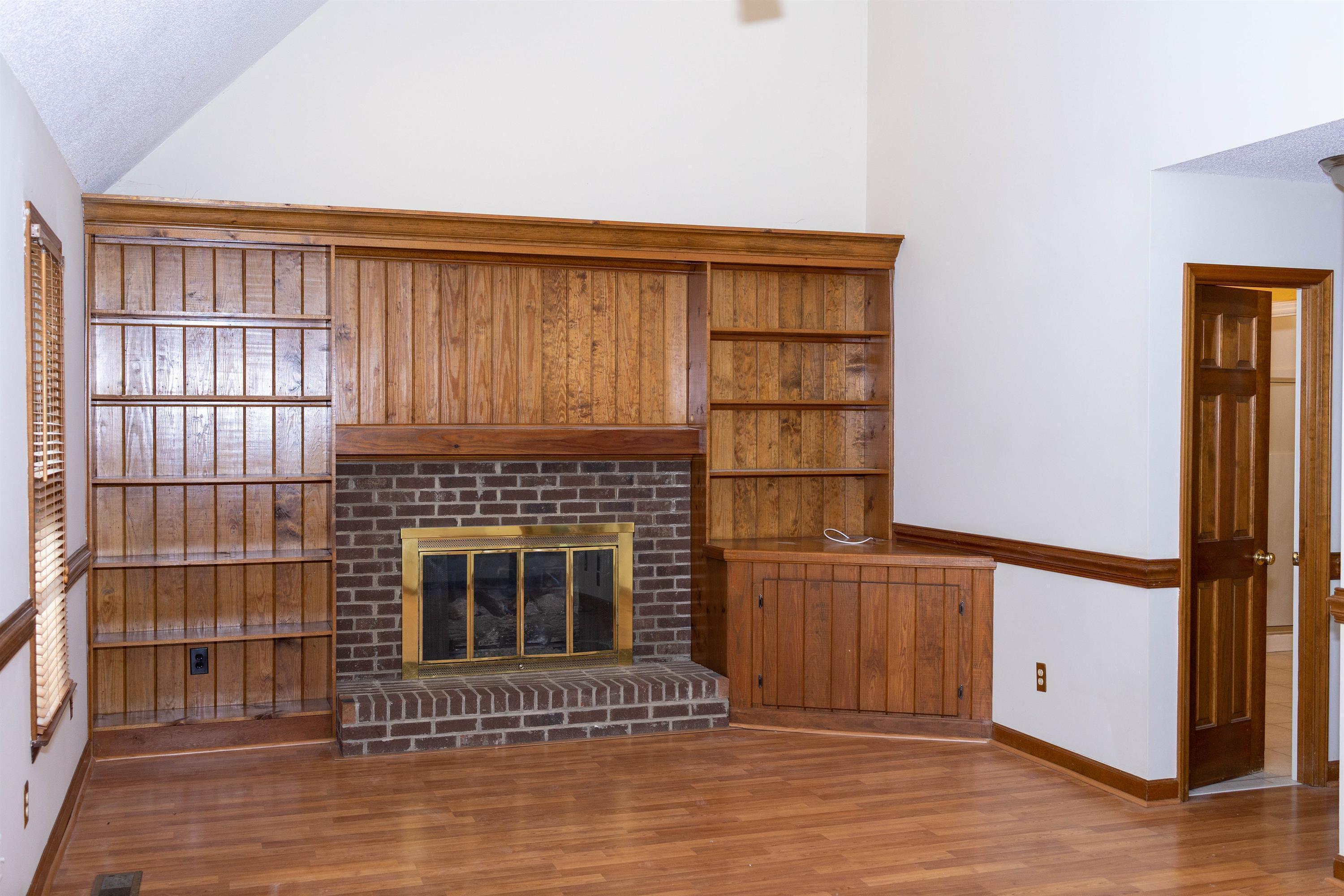 2704 Moorsfield Court Raleigh, NC 27604 - Photo 3 of 25 a view of a livingroom with wooden floor and a fireplace