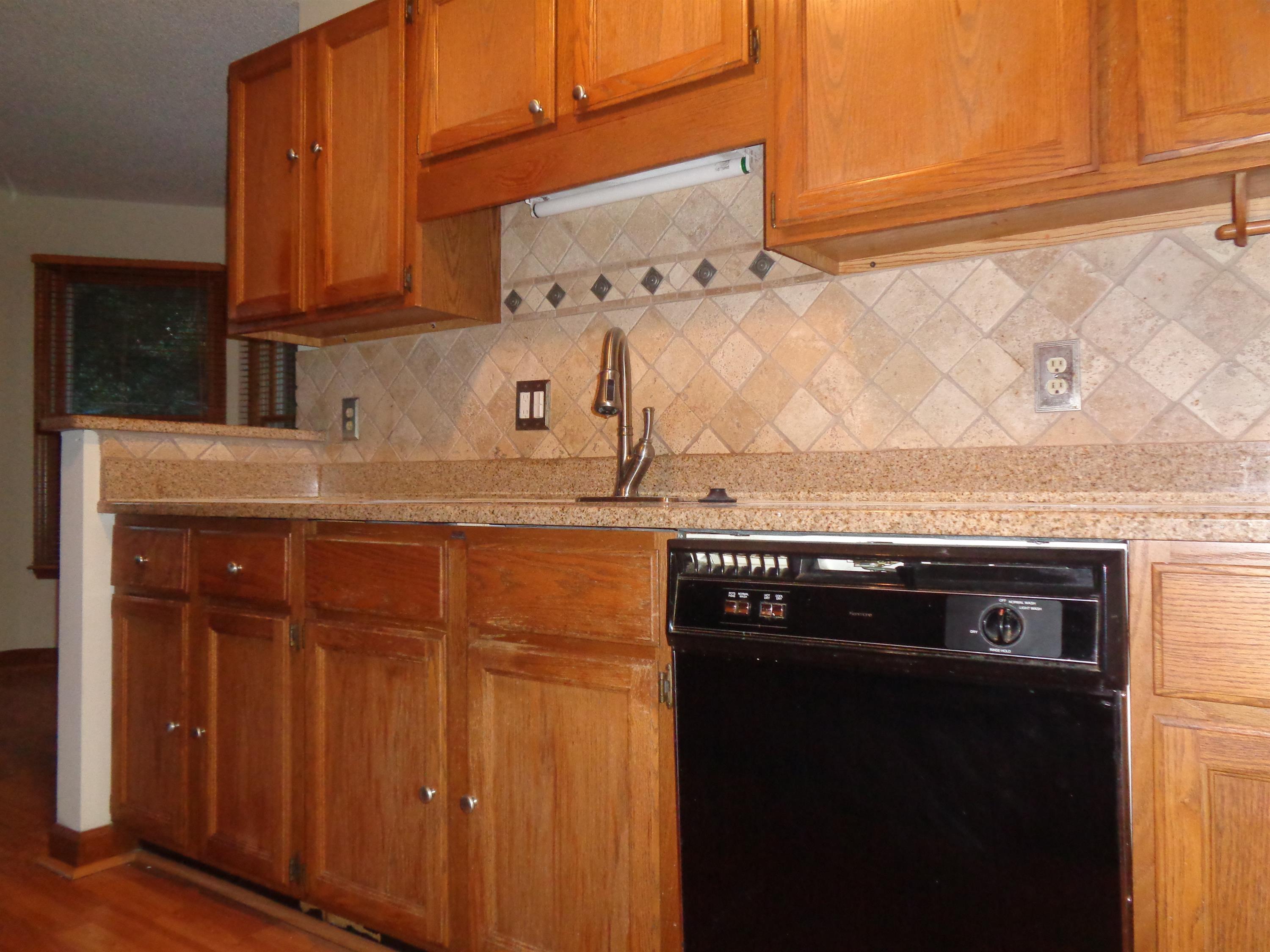 2704 Moorsfield Court Raleigh, NC 27604 - Photo 6 of 25 a kitchen with granite countertop cabinets and black appliances