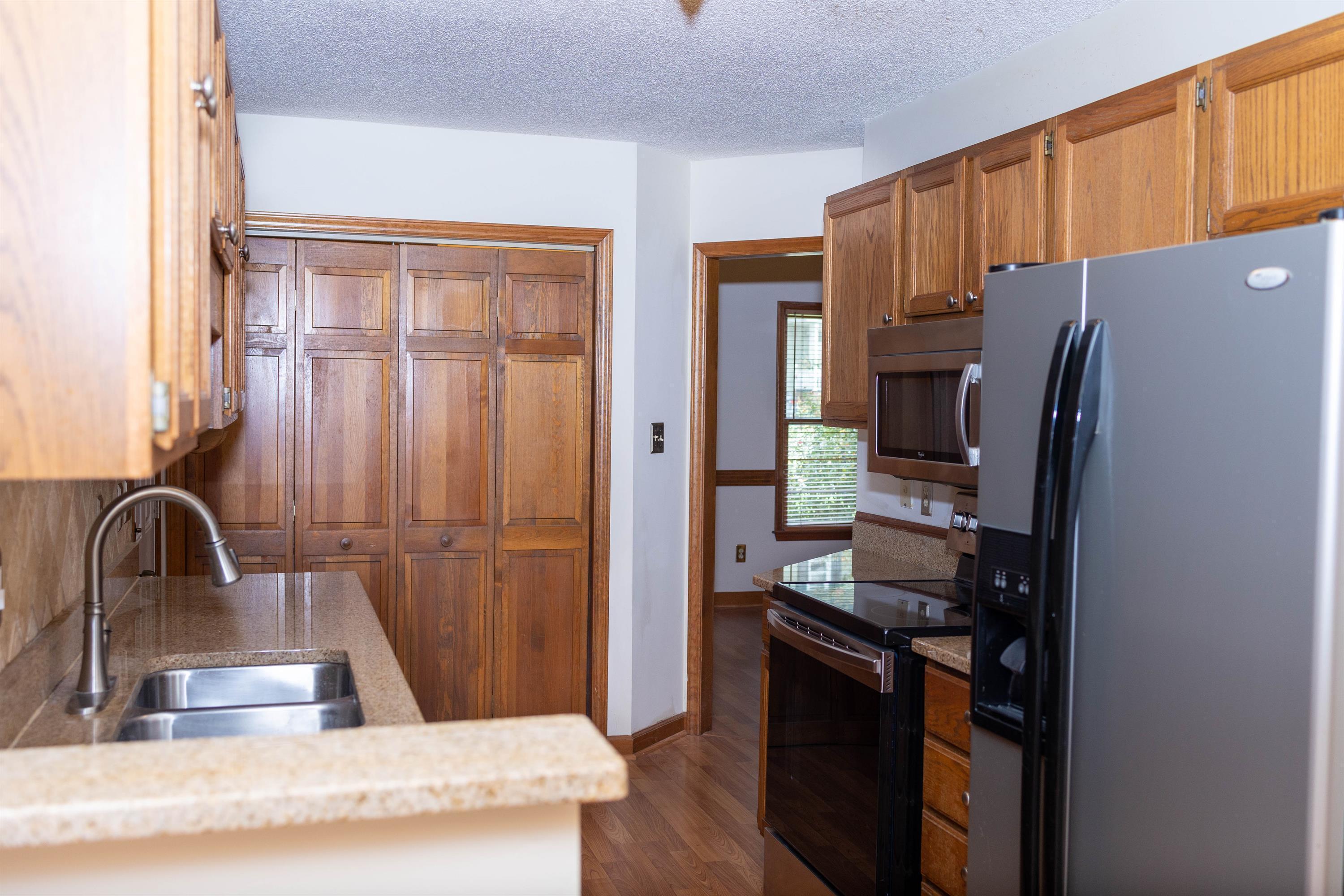 2704 Moorsfield Court Raleigh, NC 27604 - Photo 7 of 25 a kitchen with stainless steel appliances granite countertop a refrigerator and a sink