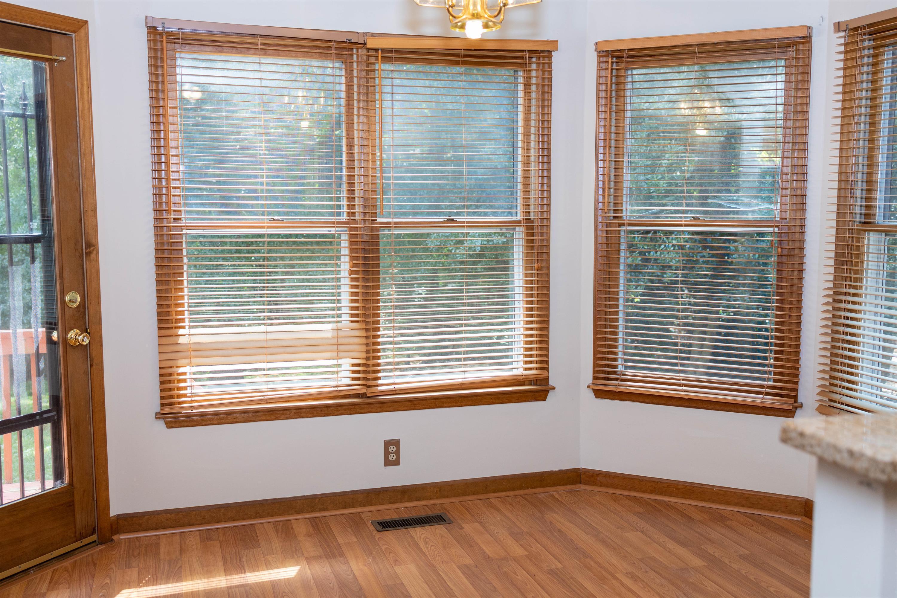 2704 Moorsfield Court Raleigh, NC 27604 - Photo 9 of 25 a view of an empty room with wooden floor and a window