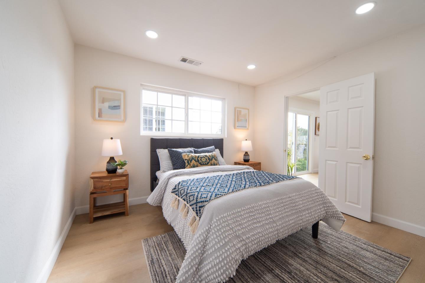 8567 Galindo Drive Dublin, CA 94568 - Photo 17 of 41 a bedroom with a bed and wooden floor