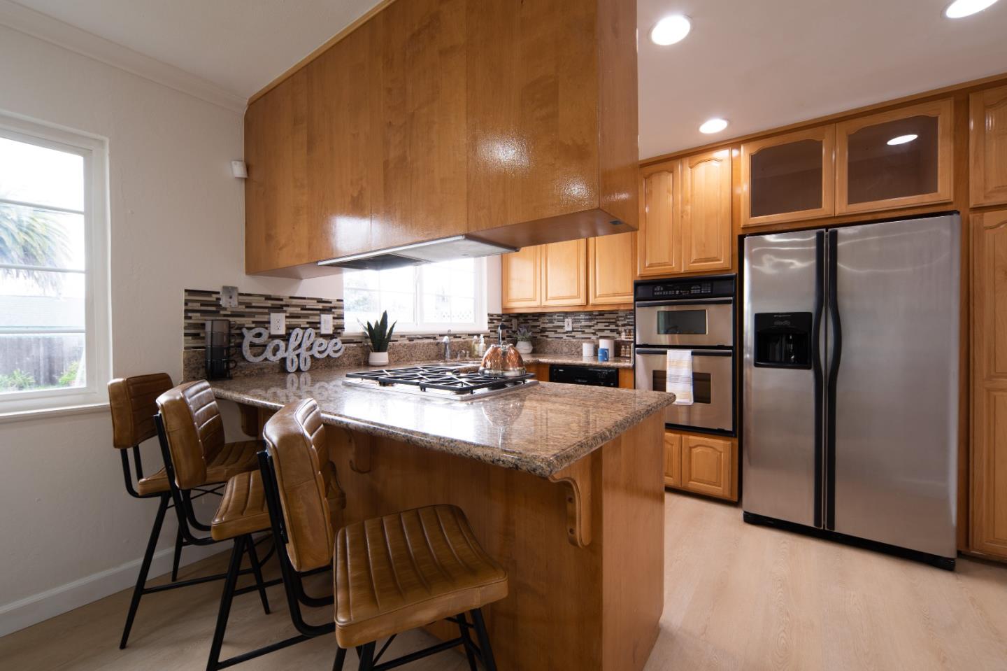 8567 Galindo Drive Dublin, CA 94568 - Photo 23 of 41 a kitchen with refrigerator and chairs