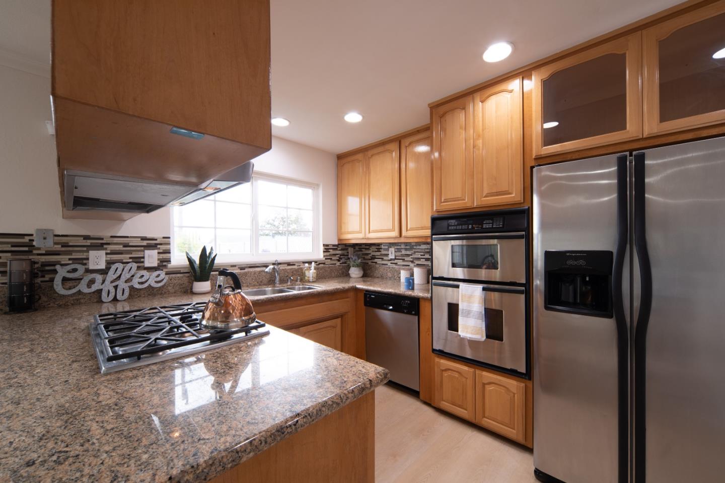 8567 Galindo Drive Dublin, CA 94568 - Photo 24 of 41 a kitchen with stainless steel appliances granite countertop a stove refrigerator sink and cabinets