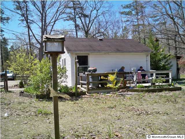92 Toms River Road Jackson, NJ 08527 - Photo 5 of 8 a view of a house with backyard wooden and a table and chairs