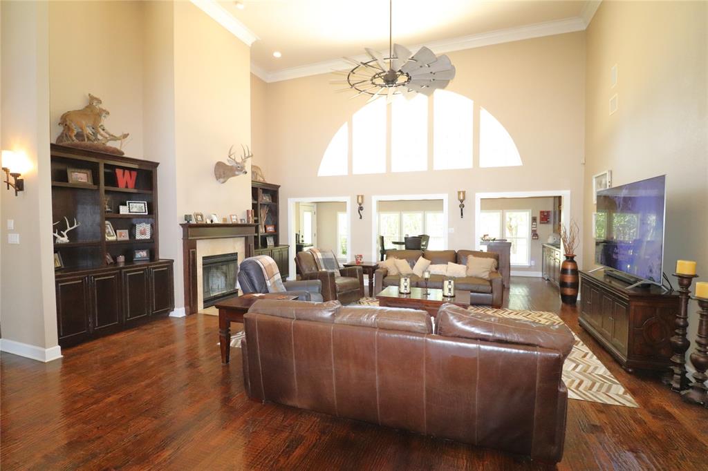 2642 Huddleston Road Sunset, TX 76270 - Photo 11 of 40 a living room with fireplace furniture and a chandelier