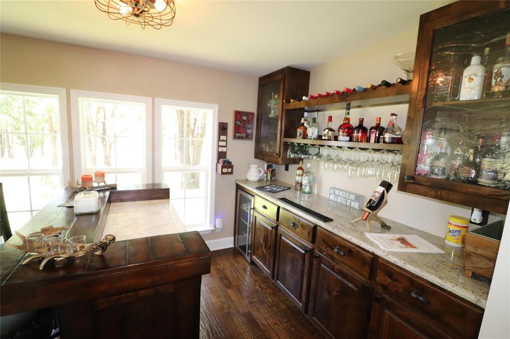 2642 Huddleston Road Sunset, TX 76270 - Photo 13 of 40 a large kitchen with a large window and stainless steel appliances