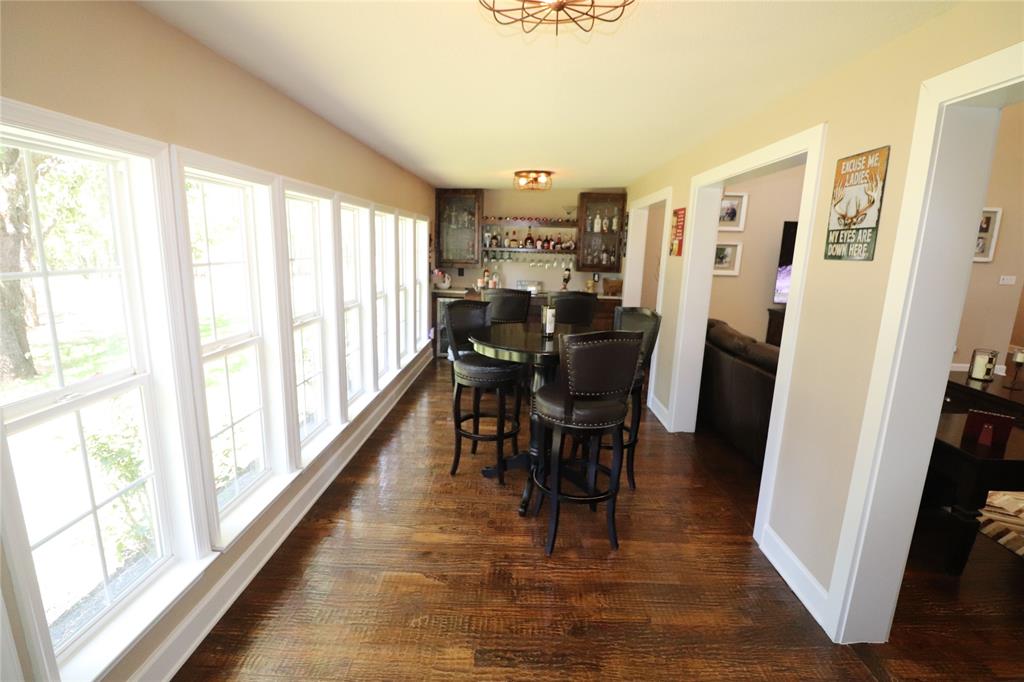 2642 Huddleston Road Sunset, TX 76270 - Photo 14 of 40 a view of a dining room with furniture window and wooden floor