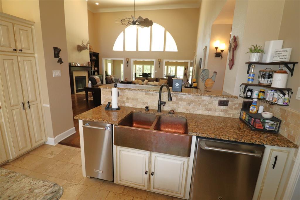 2642 Huddleston Road Sunset, TX 76270 - Photo 15 of 40 a kitchen with stainless steel appliances granite countertop a sink and a refrigerator