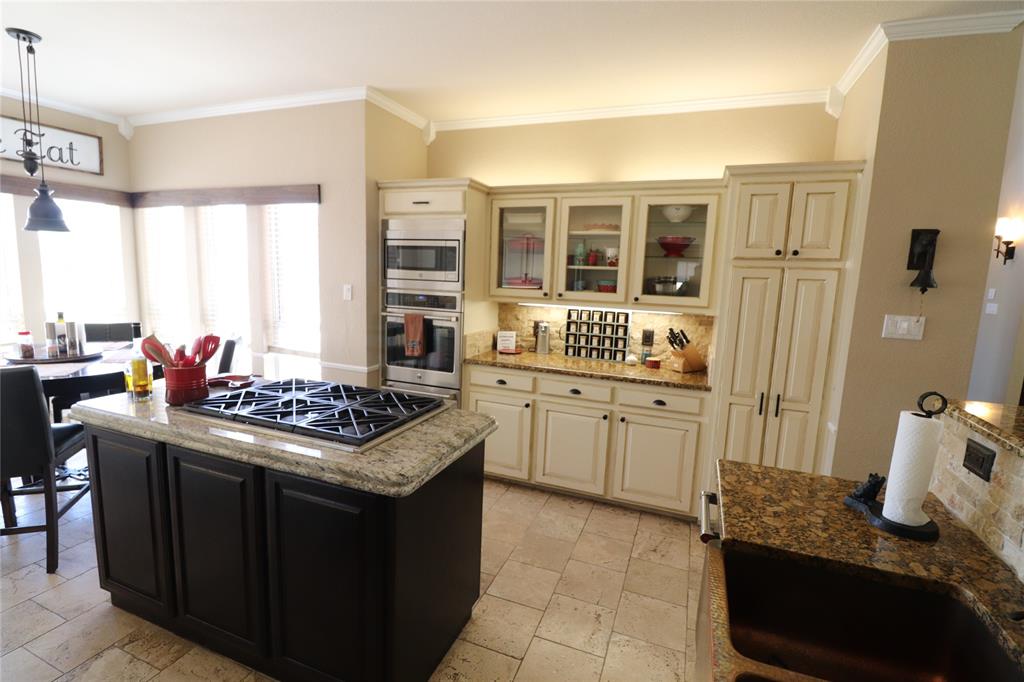 2642 Huddleston Road Sunset, TX 76270 - Photo 17 of 40 a kitchen with a stove and a sink