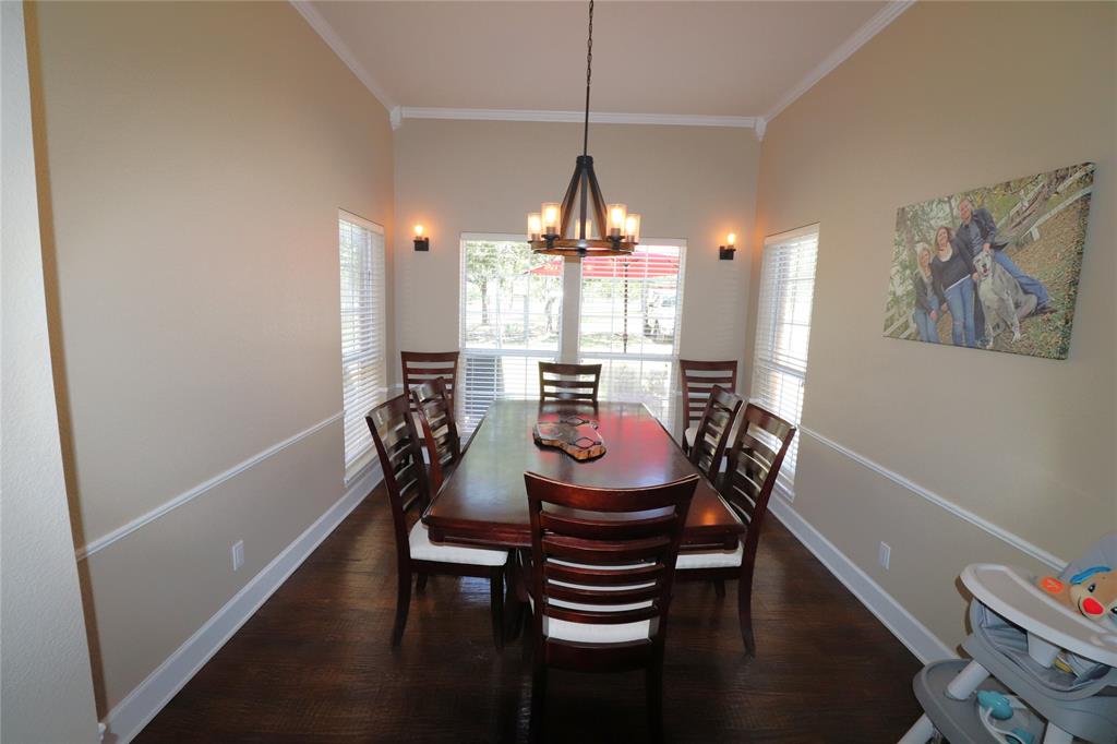 2642 Huddleston Road Sunset, TX 76270 - Photo 18 of 40 a view of a dining room with furniture window and wooden floor