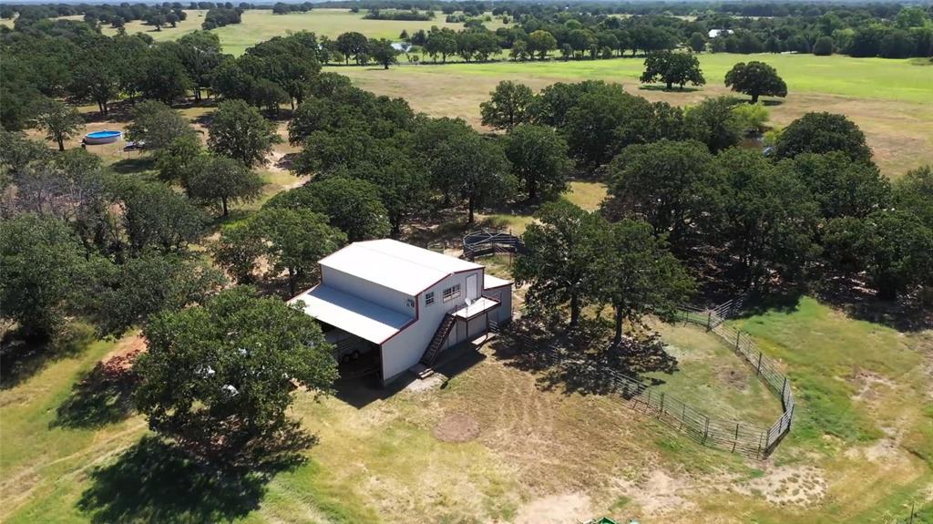 2642 Huddleston Road Sunset, TX 76270 - Photo 32 of 40 a view of a yard with wooden fence and trees