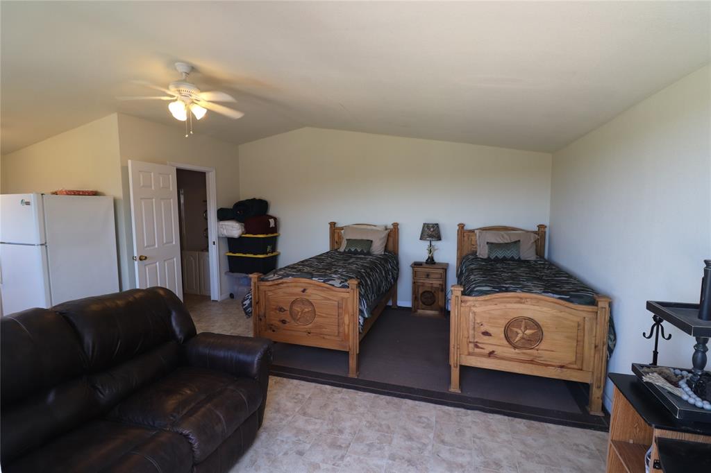 2642 Huddleston Road Sunset, TX 76270 - Photo 34 of 40 a living room with furniture and a chandelier