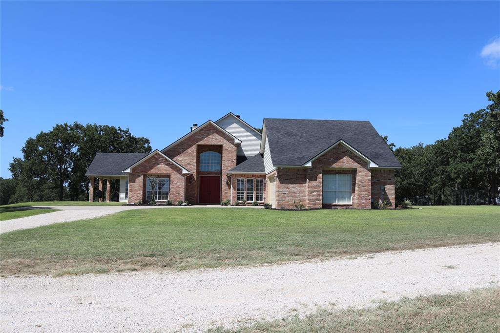 2642 Huddleston Road Sunset, TX 76270 - Photo 4 of 40 a front view of a house with a yard and garage
