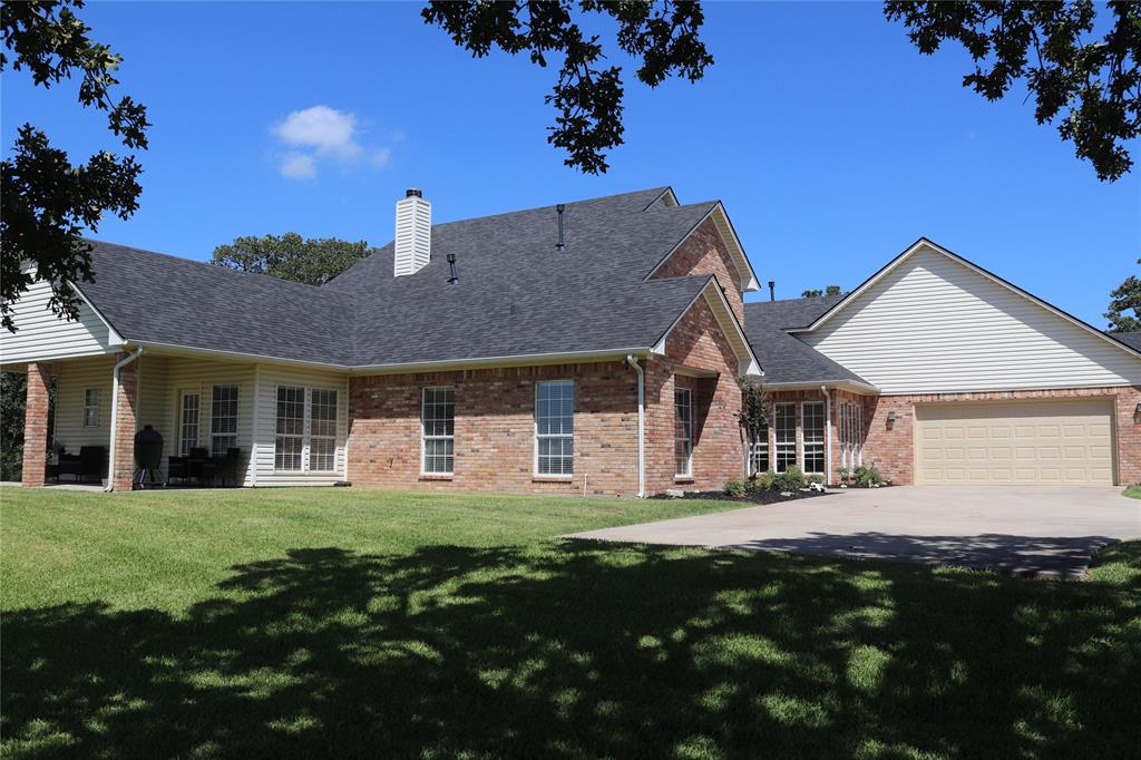 2642 Huddleston Road Sunset, TX 76270 - Photo 6 of 40 a front view of a house with a garden