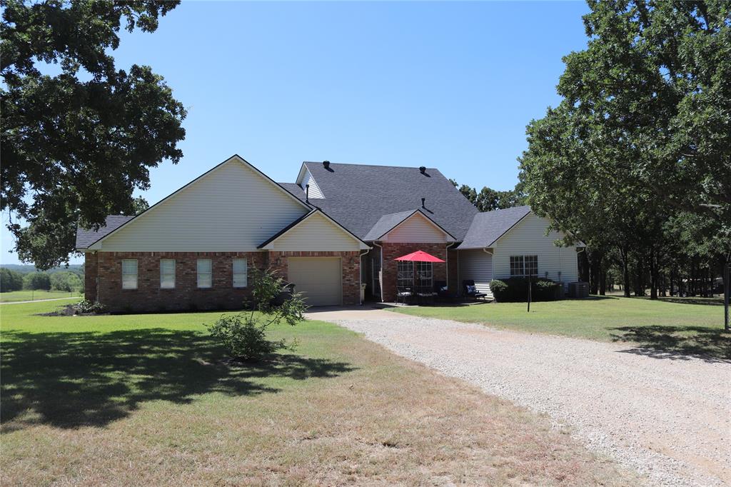 2642 Huddleston Road Sunset, TX 76270 - Photo 9 of 40 a front view of a house with a yard
